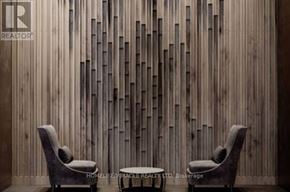 Toronto (Church-Yonge Corridor) condo for rent - Two chairs and a table are in front of a wooden wall.