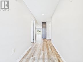 Morris Turnberry (Turnberry) townhouse for rent - A long hallway with wood floors and white walls.
