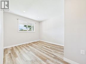 Morris Turnberry (Turnberry) townhouse for rent - A room with wooden flooring and a window showing trees outside.
