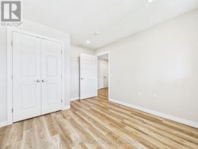 Morris Turnberry (Turnberry) townhouse for rent - A room with white walls and wooden flooring, with a door on the left and a hallway on the right.