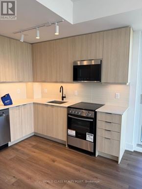 Milton (Om Old Milton) condo for rent - A kitchen with wooden cabinets and a black oven.