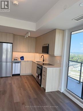 Milton (Om Old Milton) condo for rent - A kitchen with wooden cabinets and a refrigerator.