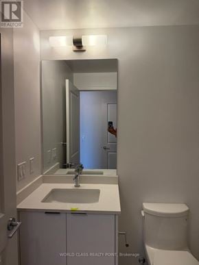 Milton (Om Old Milton) condo for rent - A bathroom with a sink, mirror, and toilet.