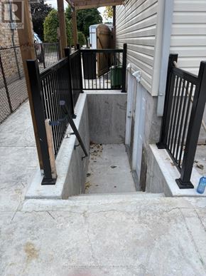 London South (South Y) apartment for rent - A concrete stairway with black railings leading to a door.