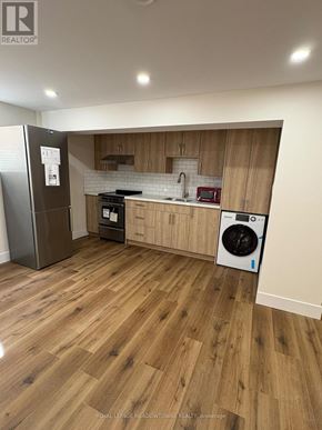 London South (South Y) apartment for rent - A kitchen with wooden cabinets and a fridge.