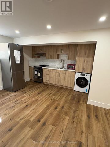 London South (South Y) apartment for rent - A kitchen with wooden cabinets and a fridge.