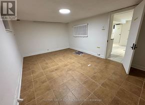 Toronto (Briar Hill-Belgravia) apartment for rent - A room with a tiled floor and a radiator on the wall.