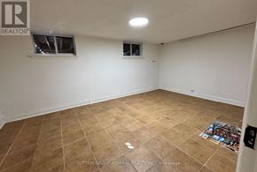 Toronto (Briar Hill-Belgravia) apartment for rent - A room with tiled flooring and two windows.