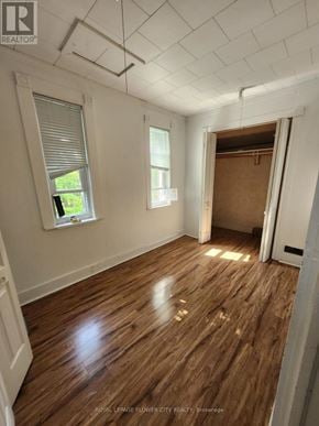 Melancthon apartment for rent - A room with wooden floors and white walls, with a window and a door.