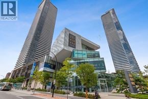 Burnaby apartment for rent - A modern building with a glass facade and a sign that reads "HOMES".