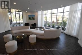Niagara Falls (Oldfield) condo for rent - A living room with a white couch and a glass table.