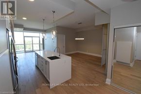 Niagara Falls (Oldfield) condo for rent - A spacious kitchen with wooden floors and a large island in the middle.