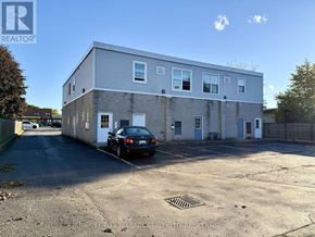 Niagara Falls (Stamford) apartment for rent - A parking lot with a building and a car.