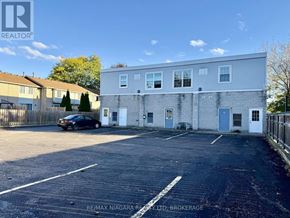 Niagara Falls (Stamford) apartment for rent - A parking lot with a building and a car in the background.