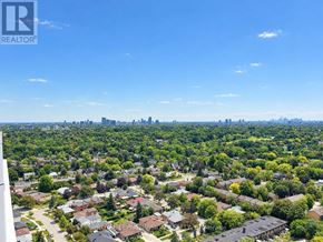 Toronto (Humber Heights) condo for rent - A bird's eye view of a residential area with houses and trees.