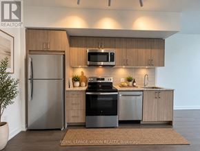 Toronto (Humber Heights) condo for rent - A modern kitchen with a refrigerator, oven, and microwave.
