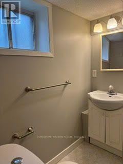 Toronto (West Humber-Clairville) apartment for rent - A small bathroom with a toilet, sink, and mirror.