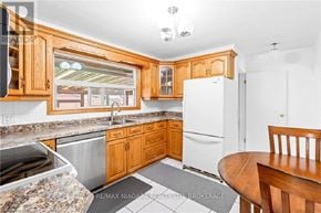 Welland (Dain City) apartment for rent - A kitchen with wooden cabinets and a white refrigerator.