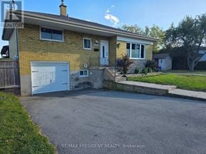 Burlington (Mountainside) apartment for rent - A house with a white garage door is for sale.