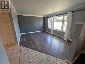 Burlington (Mountainside) apartment for rent - A room with a large window and wooden flooring.