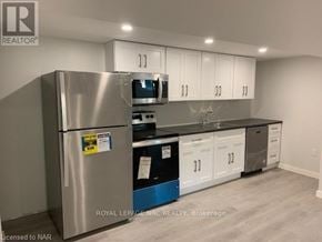 St. Catharines (Bunting/Linwell) apartment for rent - A kitchen with a stainless steel refrigerator and white cabinets.