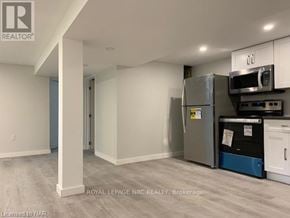 St. Catharines (Bunting/Linwell) apartment for rent - A kitchen area with a refrigerator, microwave, and oven.