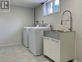 St. Catharines (Bunting/Linwell) apartment for rent - A white sink is in a white kitchen with a white fridge and white cabinets.