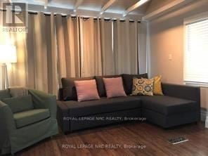 Niagara Falls (Hospital) apartment for rent - A living room with a couch and a chair.
