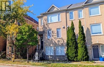 Markham (Commerce Valley) townhouse for rent - A building with a tree in front of it.