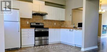 Markham (Commerce Valley) townhouse for rent - A kitchen with white cabinets and a stainless steel dishwasher.