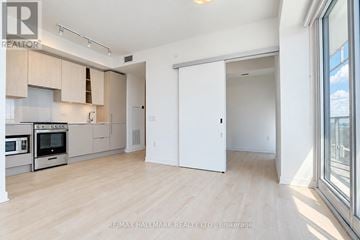 Mississauga (City Centre) condo for rent - A spacious kitchen with wooden floors and white walls.