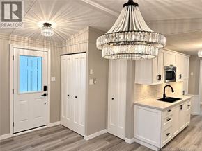 Bethel apartment for rent - A well-lit kitchen with a chandelier and a window.