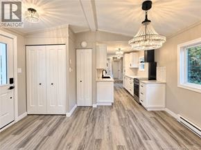 Bethel apartment for rent - A well-lit, spacious kitchen with white cabinetry and a wooden floor.