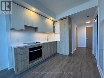 Vaughan (Vaughan Corporate Centre) condo for rent - A kitchen with wooden cabinets and a stainless steel oven.