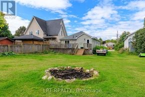Georgina (Historic Lakeshore Communities) apartment for rent - A backyard with a fire pit and a house in the background.