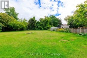 Georgina (Historic Lakeshore Communities) apartment for rent - A lush green yard with a house and trees in the background.