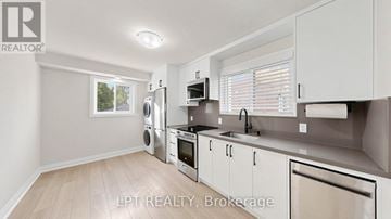 Toronto (Danforth Village-East York) apartment for rent - A modern kitchen with white cabinets and stainless steel appliances.