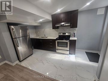 New Tecumseth (Tottenham) apartment for rent - A kitchen with a stainless steel refrigerator and a stove top oven.