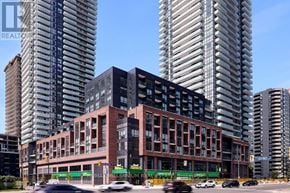 Mississauga (Creditview) condo for rent - A modern building with a green sign that says "MILLENNIUM" in front of two very tall buildings.