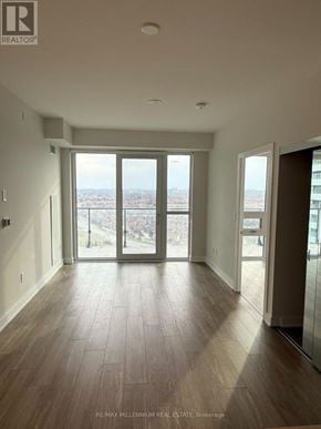 Mississauga (Creditview) condo for rent - A spacious room with a view of the city through large windows.