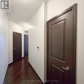 Mississauga (City Centre) condo for rent - A hallway with a brown door and a white wall.