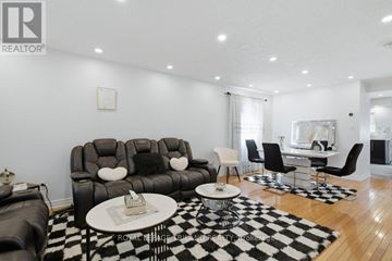 London South (South U) apartment for rent - A living room with a black and white checkered rug and a black leather couch.