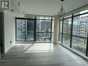 Toronto (Church-Yonge Corridor) condo for rent - A spacious room with large windows overlooking a cityscape.