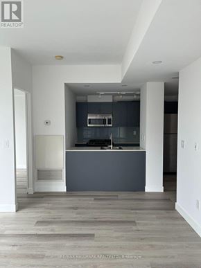 Toronto (Church-Yonge Corridor) condo for rent - A modern kitchen with a large island and a fireplace.
