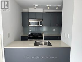 Toronto (Church-Yonge Corridor) condo for rent - A kitchen with a sink and a stove top oven.