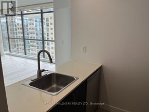Toronto (Church-Yonge Corridor) condo for rent - A kitchen with a sink and a window overlooking a city.