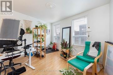 Toronto (Little Portugal) apartment for rent - A living room with a green chair and a wooden shelf.