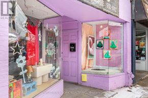 Toronto (Little Portugal) apartment for rent - A purple storefront with a black door and a sign that says "Victoria & York Realty Inc., Brokerage.".