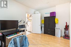 Toronto (Little Portugal) apartment for rent - A room with a TV, a chair, and a vacuum cleaner.