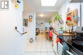 Toronto (Little Portugal) apartment for rent - A kitchen with a white fridge and a white tiled floor.